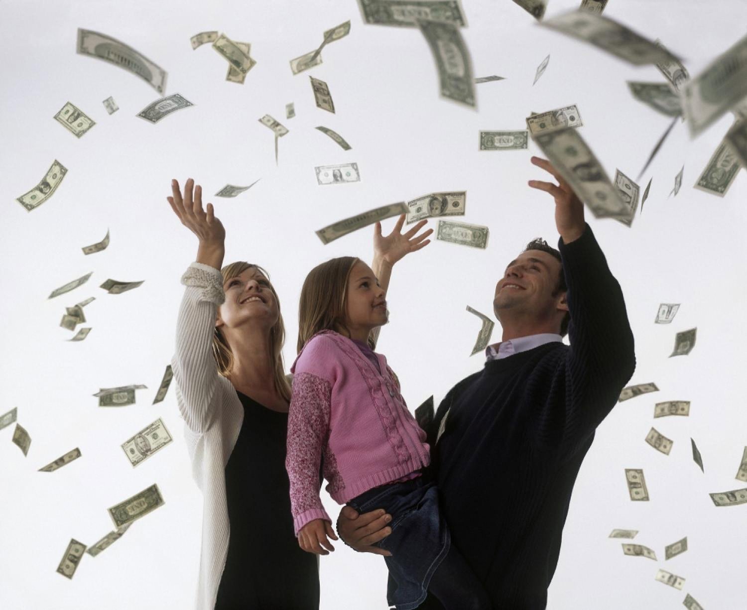 A family throwing money in the air, symbolising financial freedom for UAE households